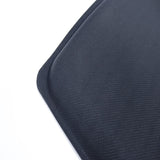 Close-up view of a black, textured desk mat with a curved corner on a white background, reminiscent of the durable BYD Seal Floor All Weather Floor Mats providing excellent protection.