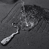 Water being poured onto a black fabric surface, like the BYD Seal Floor All Weather Floor Mats, demonstrates the car's interior protection as the liquid beads and flows off without soaking in.